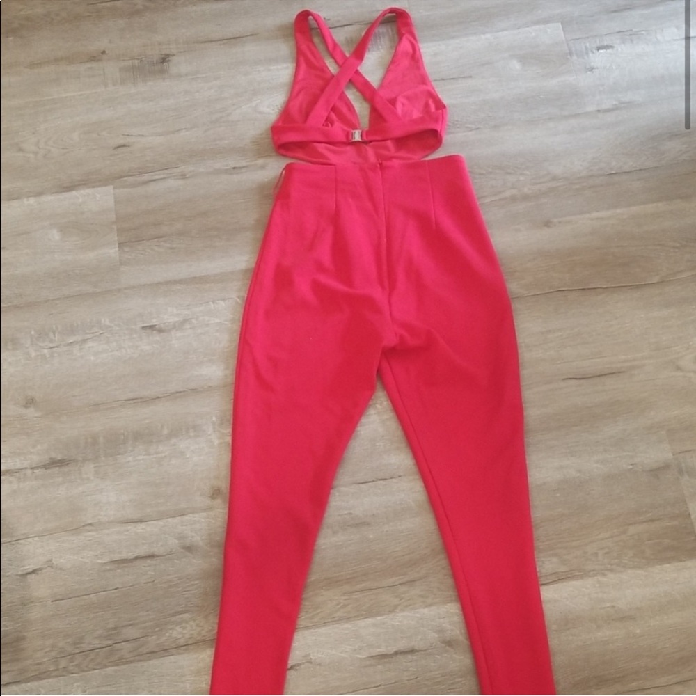 Red jumpsuit with plunging neckline